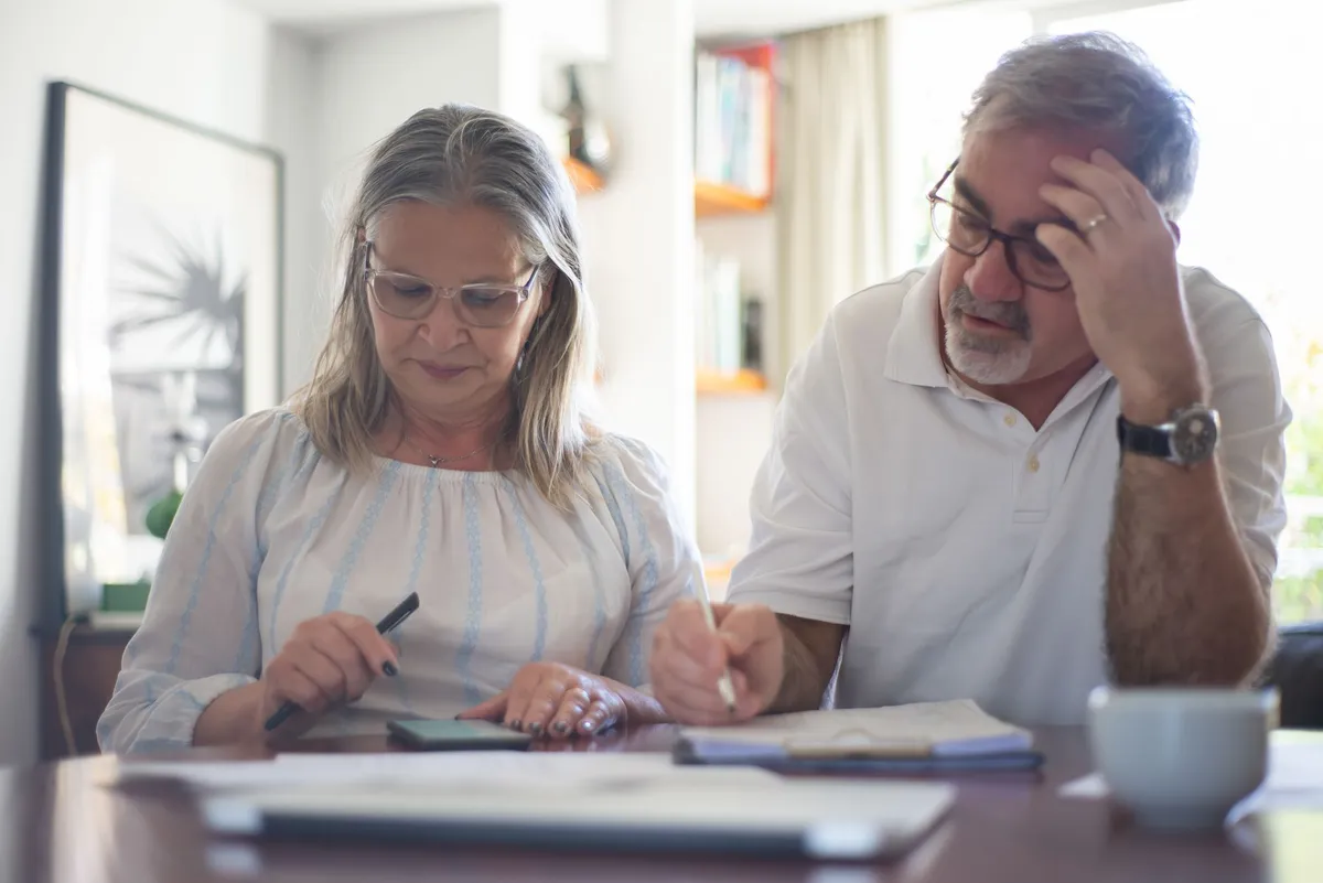 elderly couple discussing finances