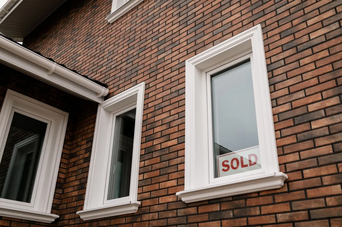 modern home with sold sign