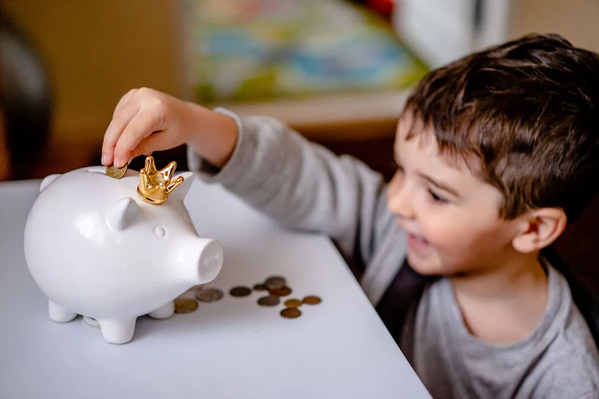 young child with piggy bank