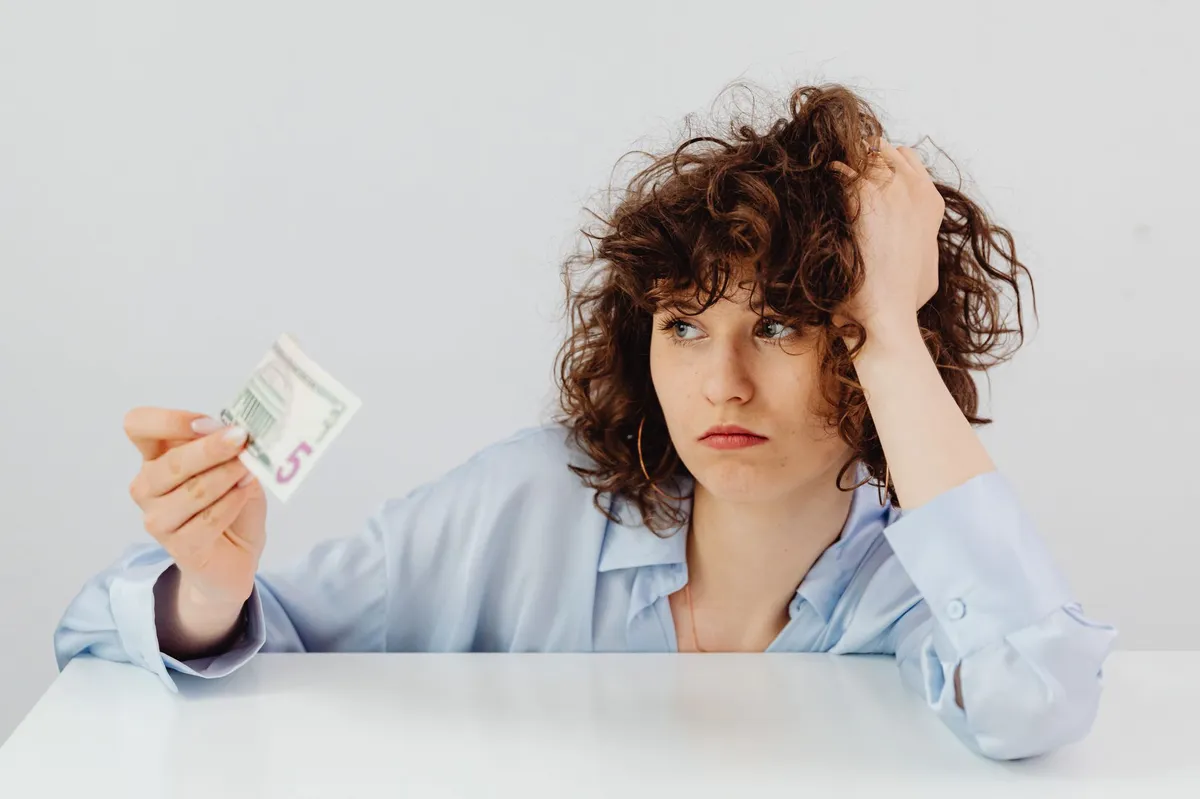 stressed young adult with bills