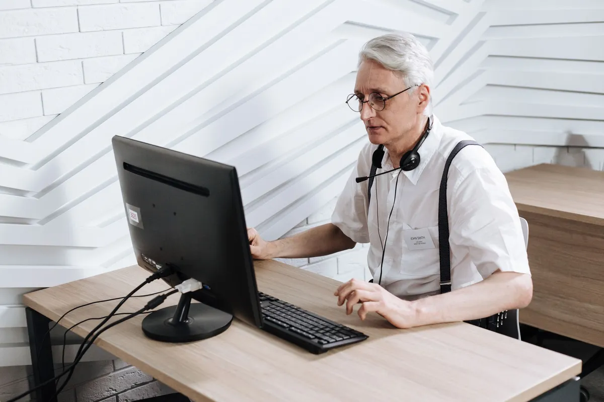 older worker engaging with technology