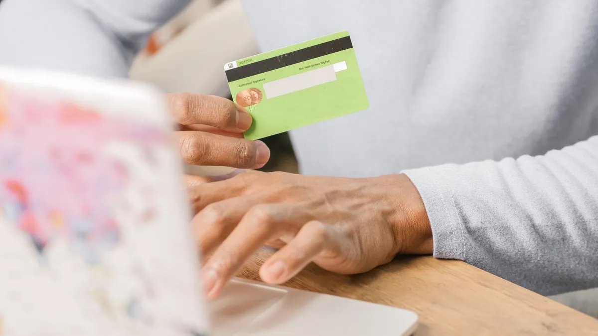 person loading prepaid card