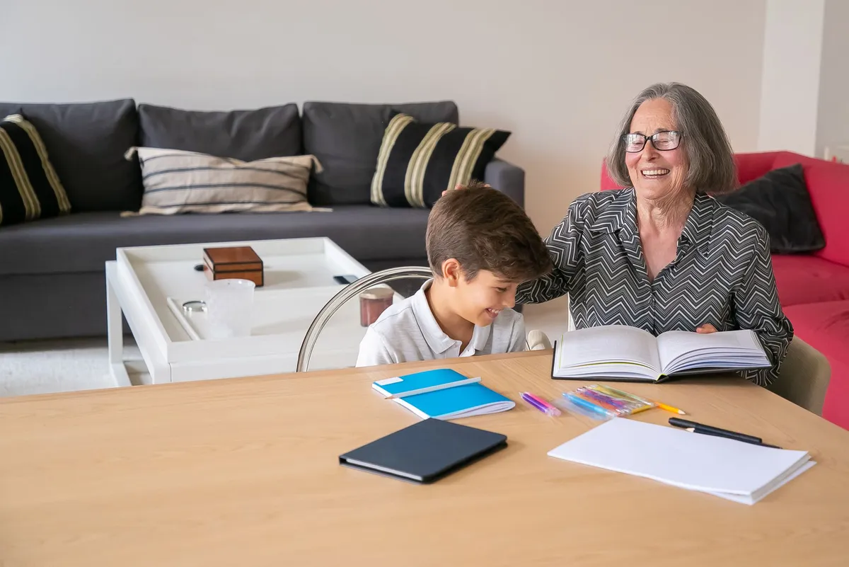 grandparent and grandchild studying together