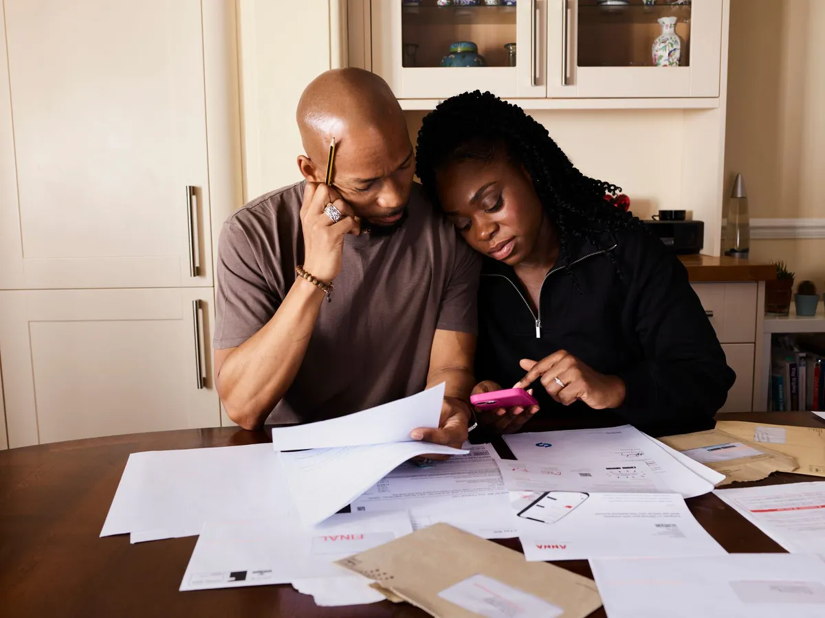 concerned elderly couple reviewing finances