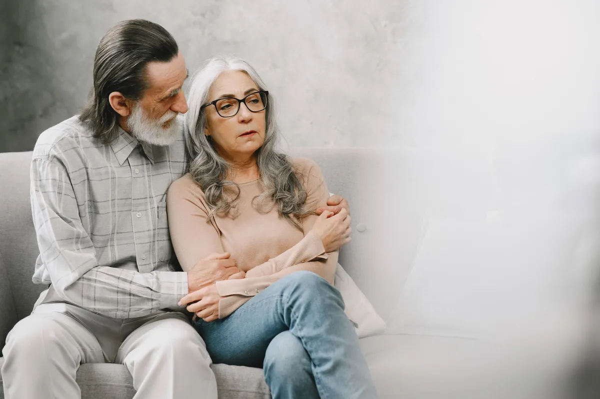 worried retirees reading mail