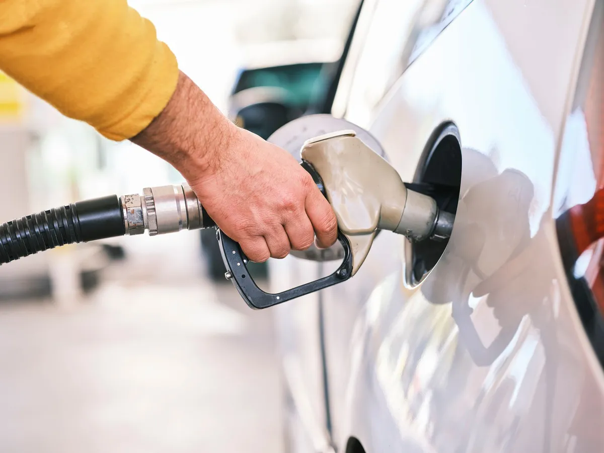 person filling gas tank
