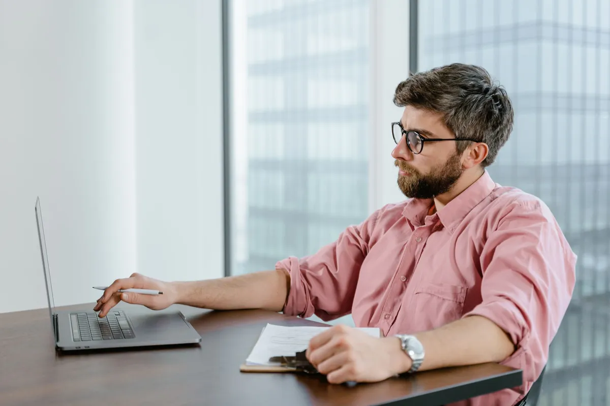 financial analyst working on laptop
