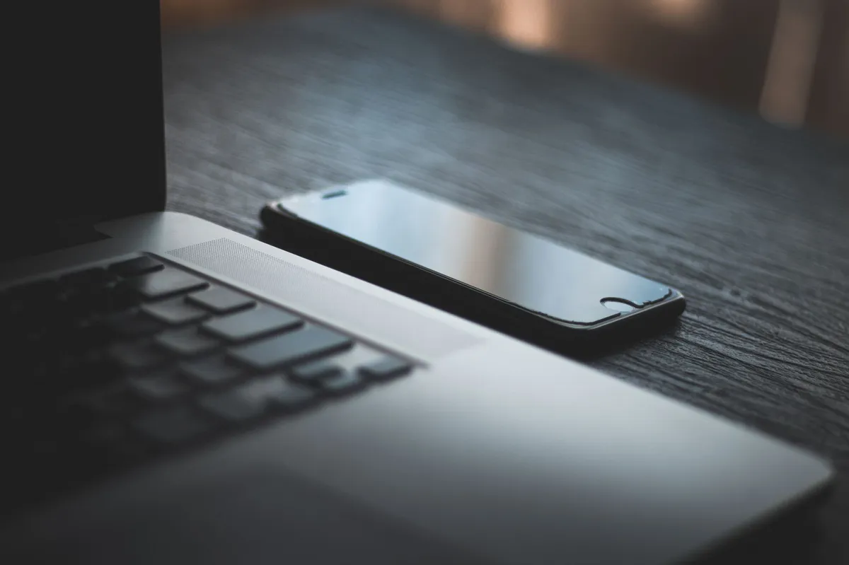 smartphone and laptop on a desk