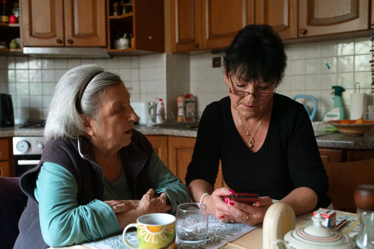 caregiver and elderly parent discussing care