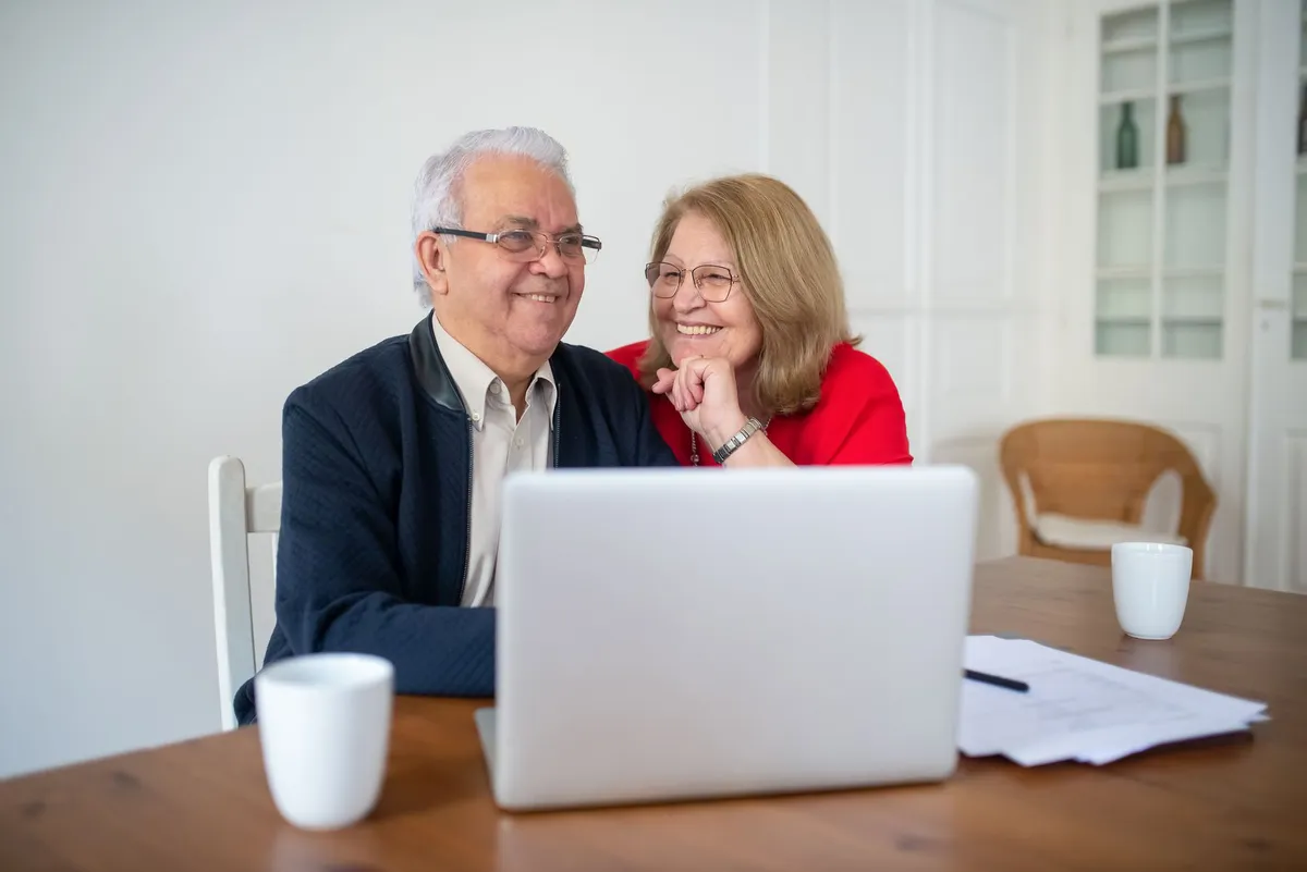 elderly couple using a laptop