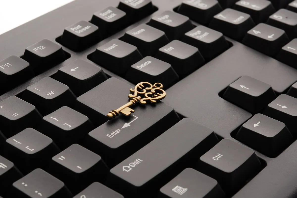 close-up of a lock and key on a computer keyboard
