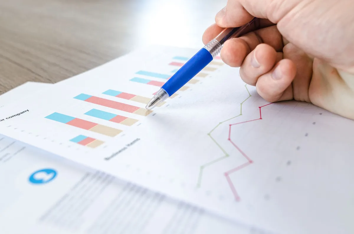 person analyzing financial charts