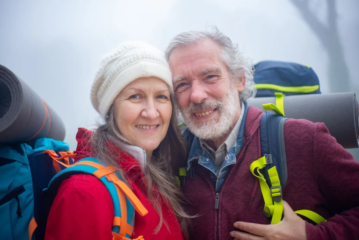 happy retired couple hiking