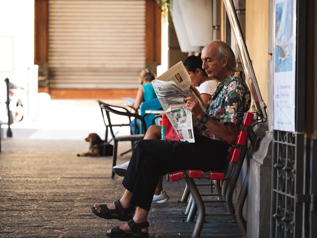 senior man reading newspaper