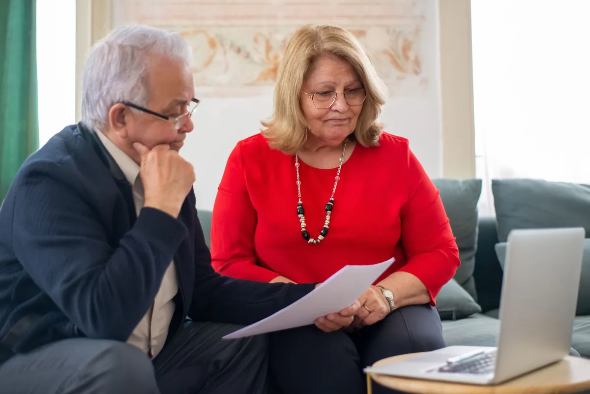 elderly couple reviewing finances
