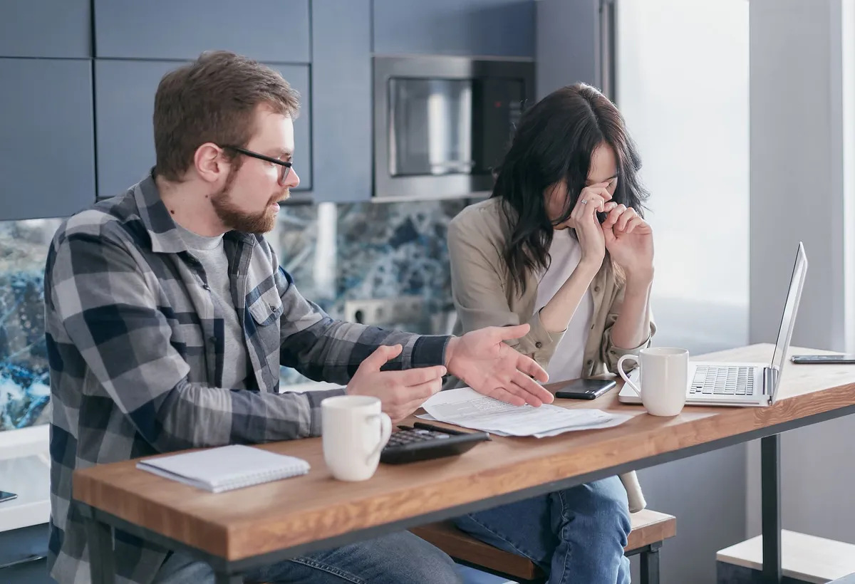 worried homeowner with bills