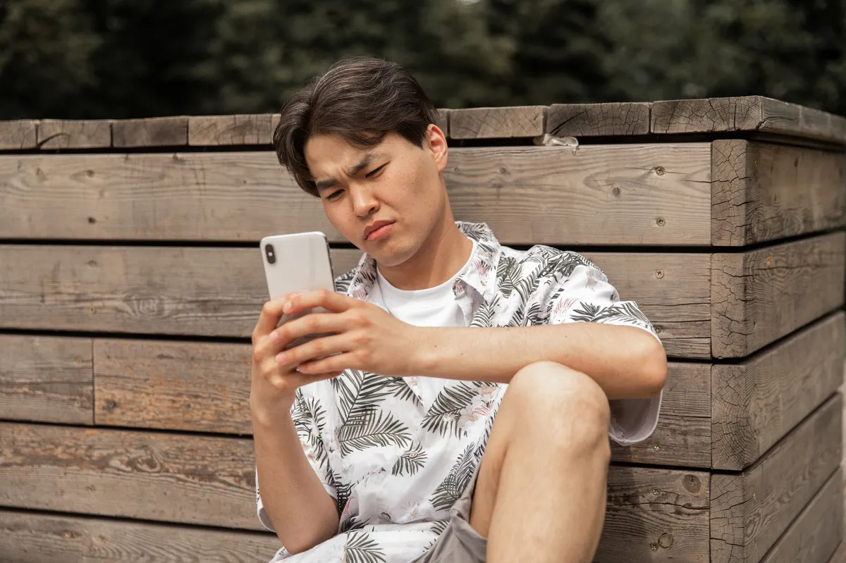 person looking at phone suspiciously