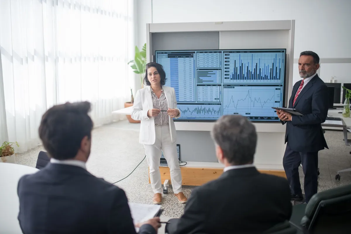 group of business professionals discussing tech stocks