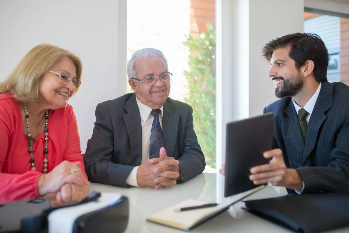 happy couple meeting with financial advisor